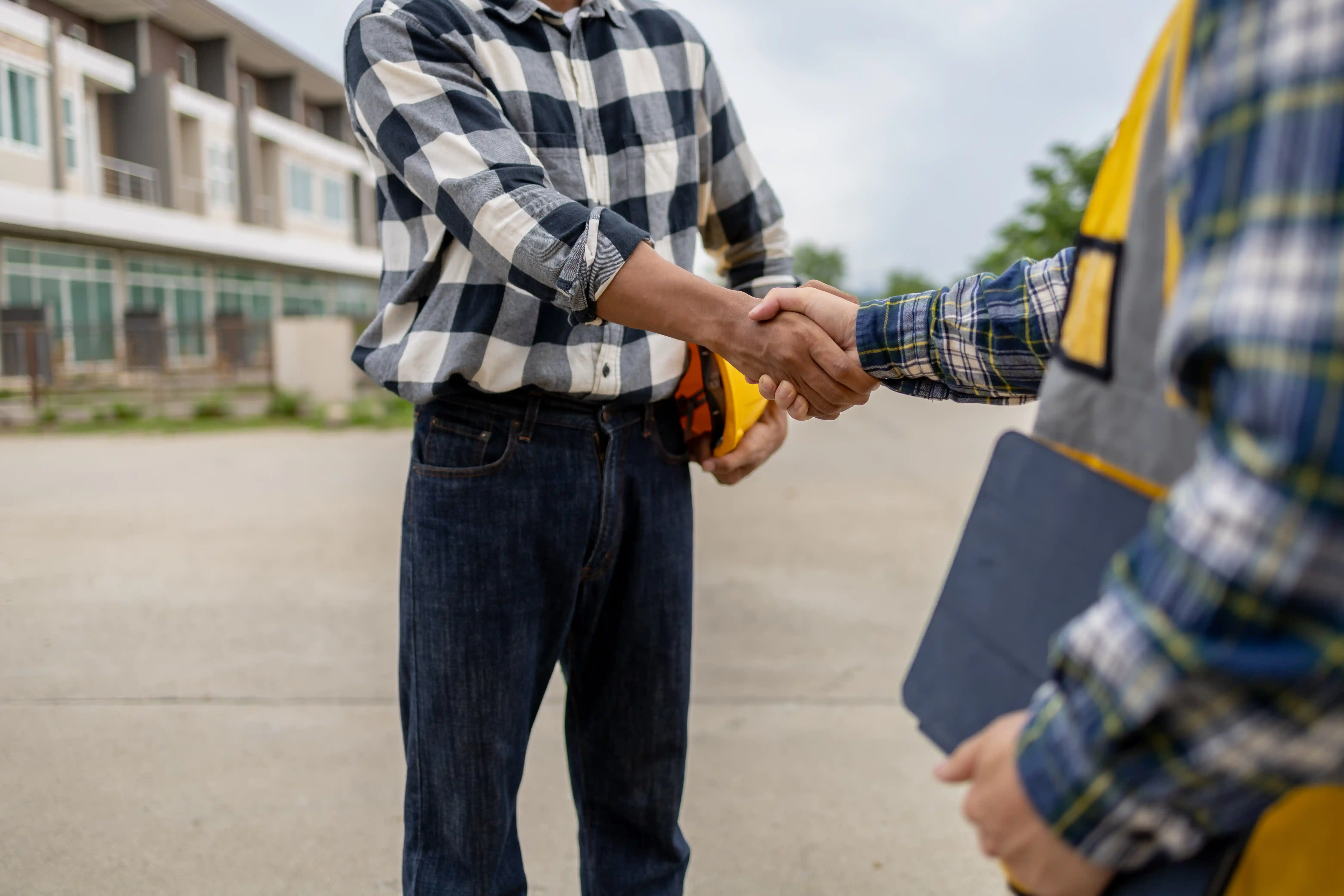 Construction management handshake — build to match approved 3D visuals